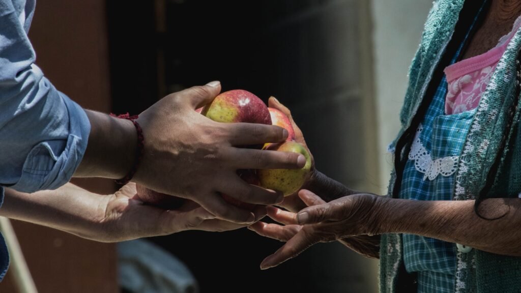 One person giving fruit. Generosity That Multiplies