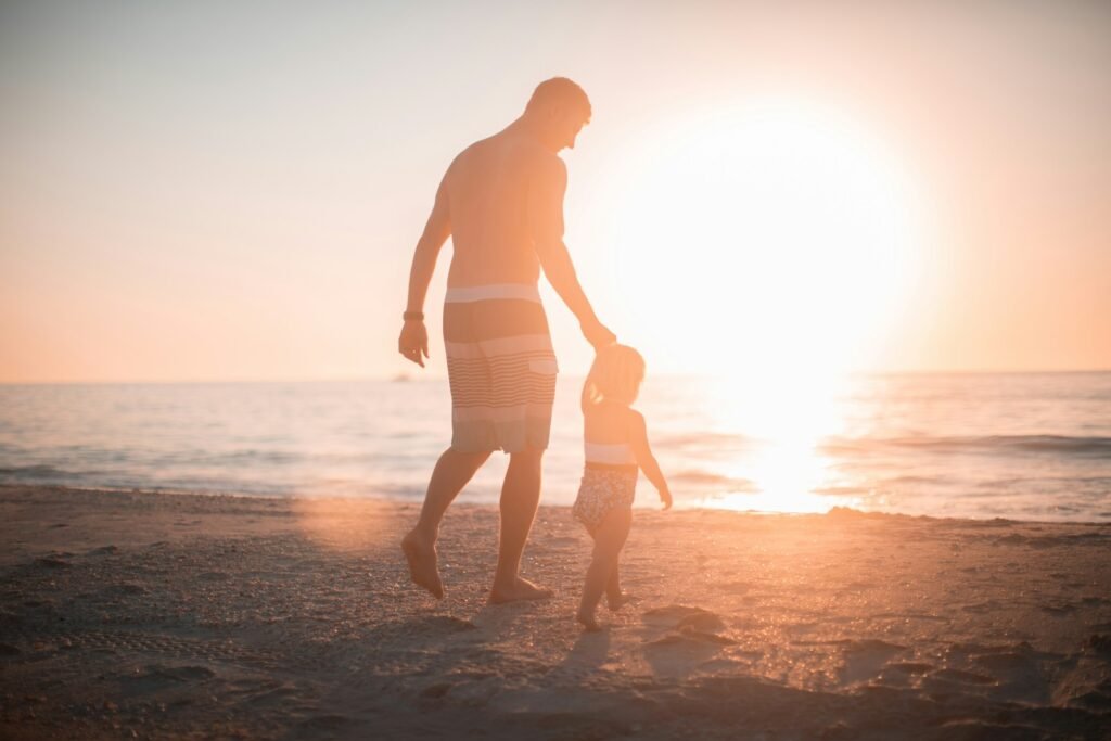 man holding girl heading towards sea. Rich dad poor dad