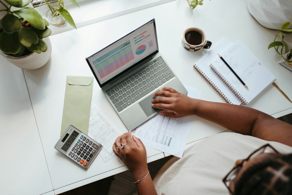 a person sitting at a table with a laptop. Batch Process