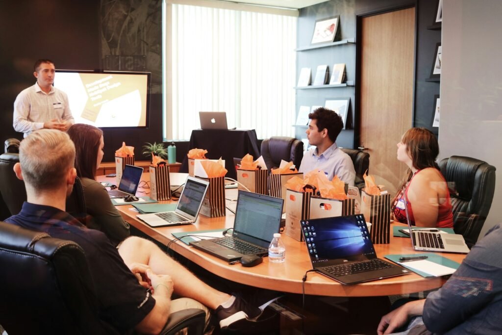 man standing in front of people sitting beside table with laptop computers, Transparent Leadership Techniques