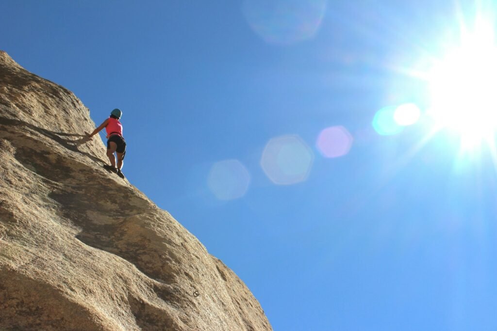 person rock climbing during day time, Overcoming every challenge