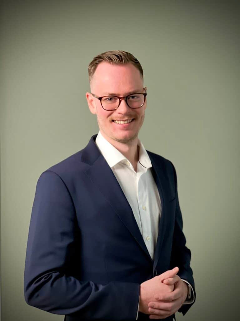 a Christian man in a suit. CEO and Founder of FaithElevate