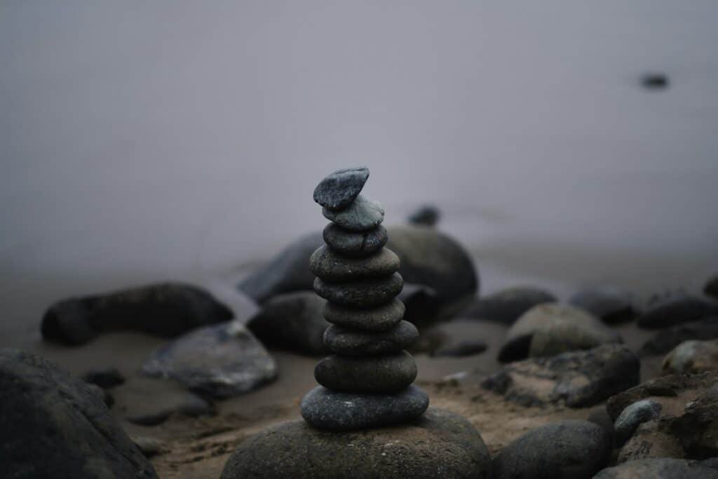 a stack of rocks sitting on top of a beach