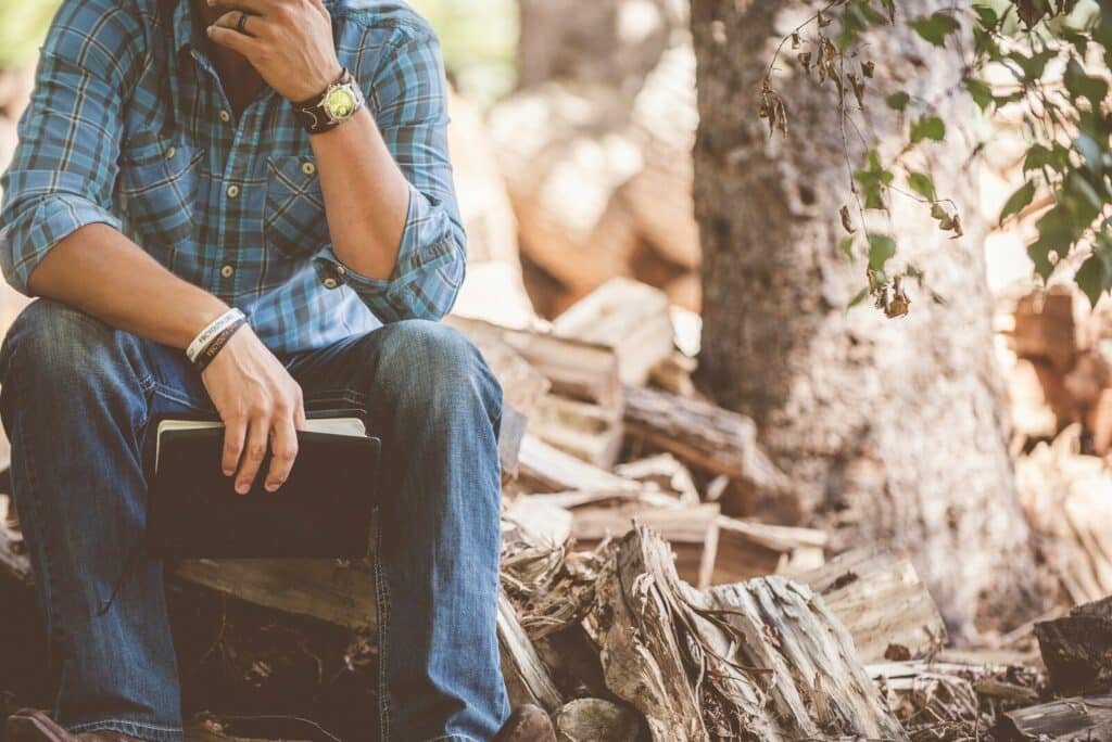 man wearing blue plaid dress shirt and blue jeans. Compassionate Authority