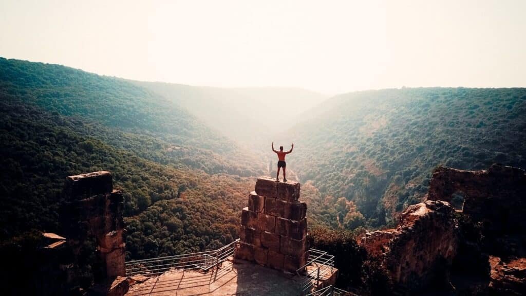 person standing on brown concrete building during daytime. Daily Habits for Champions