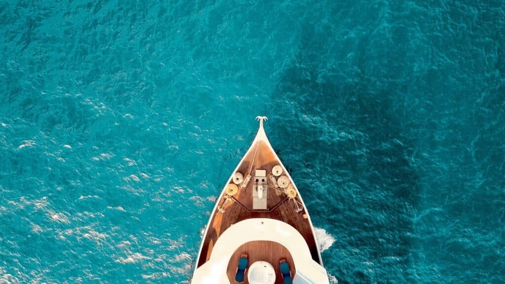 birds eye photography of boat on body of water. Luxury to Legacy